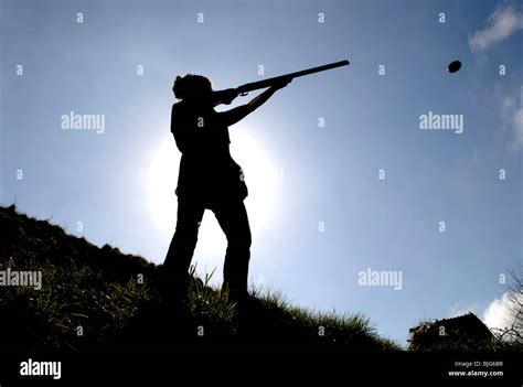 generic silhouette of a female in action shooting clay pigeons with a ...