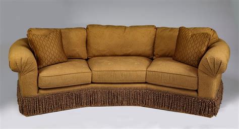 Lot - Wesley Hall curving sofa with bullion fringe skirt