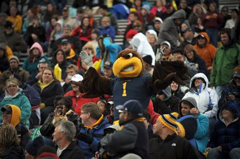 Flash, the mascot of Kent State University joins fans in cheering on the Golden Flashes during a ...