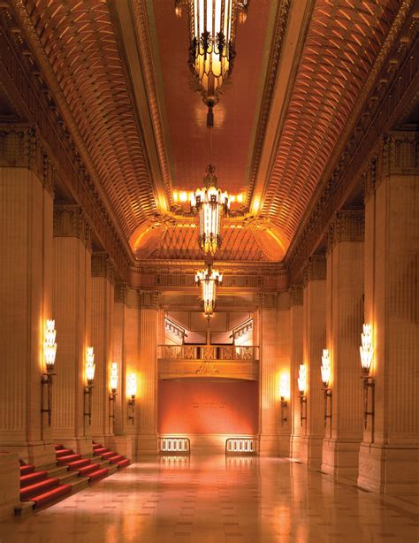 This is the grand foyer of the Civic Opera House, whose gilt cornices glitter beneath the ...