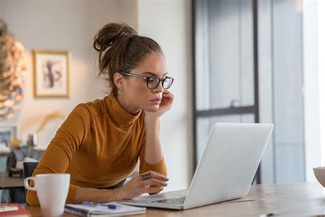 "Woman In Glasses Working On Laptop" by Stocksy Contributor "Jovo Jovanovic" - Stocksy