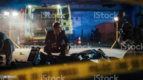 Donotcross Tapes Restricting Access To Crime Scene In A Back Alley Detective Inspecting The Body ...