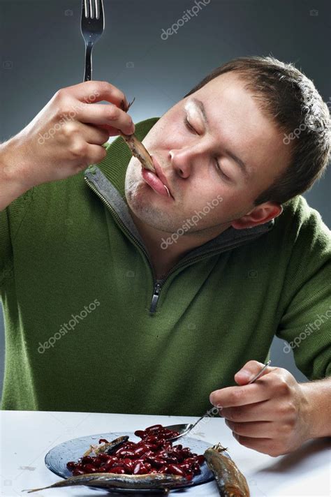 Portrait of hungry man eating fish — Stock Photo © dontcut #3924796