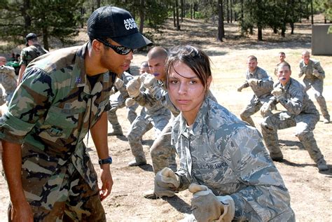 U.S. Air Force Academy Cadet 1st Class Clinton Walls directs Basic Cadet Fanita Schmidt on hand ...