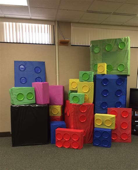 Giant LEGO blocks to make a fort. Made out of boxes, tablecloths, and paper plates, along with ...