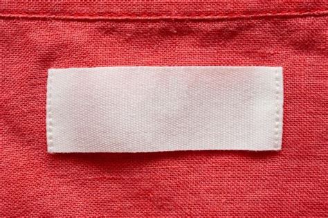 Premium Photo | Blank clothing tag label on linen shirt fabric texture background | Clothing ...