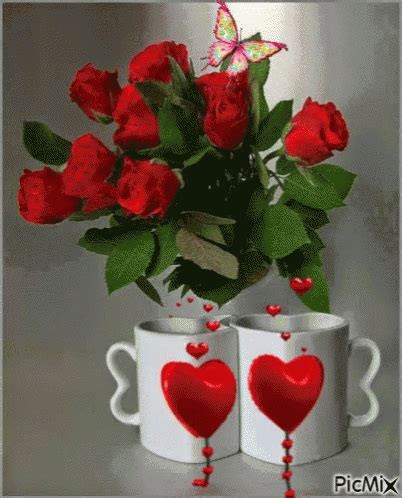 two mugs with red roses in them and hearts painted on the side, one is ...