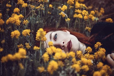 "Red Haired Woman Laying In Flowers" by Stocksy Contributor "Ani Dimi" - Stocksy