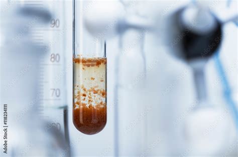 Chemical reaction-Rusty red iron(III) hydroxide precipitate (Fe(OH)3) in test tube formed ...