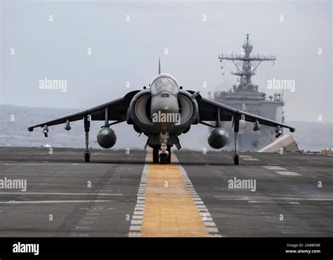 A U.S. Marine Corps AV-8B Harrier II fighter jet lands on the flight deck of the USS Boxer ...