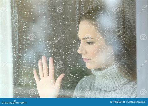 Sad Girl Looking through a Window in a Rainy Day Stock Photo - Image of homeowner, loneliness ...