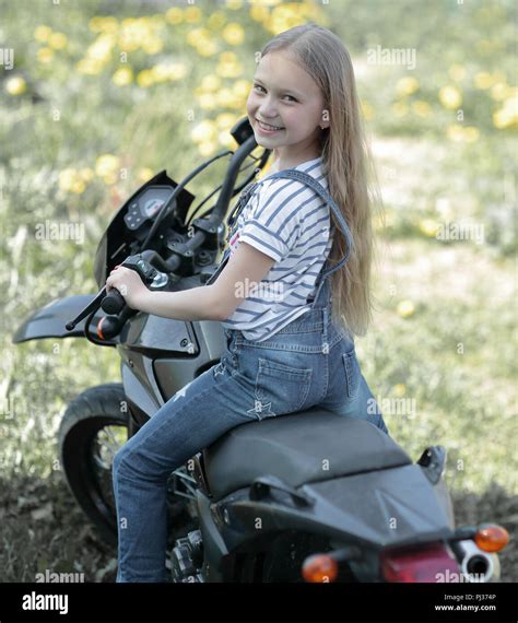 little biker girl riding her motorcycle Stock Photo - Alamy