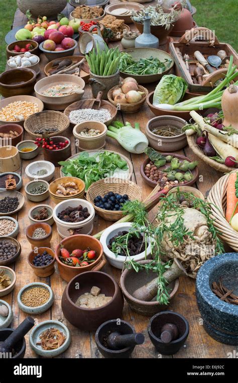 Table of medieval food including nuts seeds berries vegetables and pulses at a historical re ...