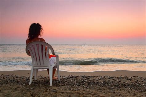 Woman Sitting On Plastic Chair On Beach Royalty Free Stock Image - Image: 17888956