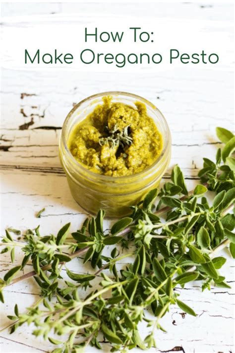 a jar filled with green pest next to some herbs