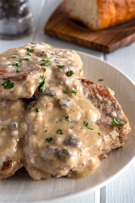 White plate of 5 baked pork chops dripping with cream of mushroom gravy | Pork chop recipes ...