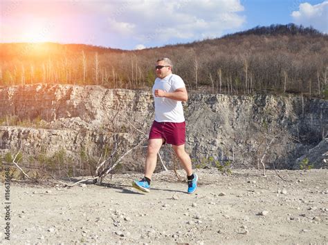 Fat man running in nature. Stock Photo | Adobe Stock