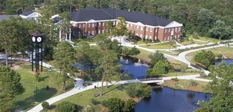 an aerial view of a large building surrounded by trees