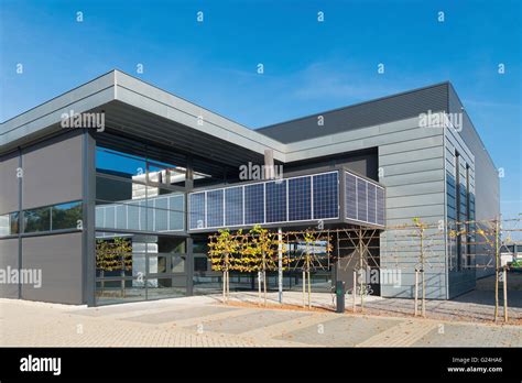 modern office building exterior with solar panels above the entrance ...