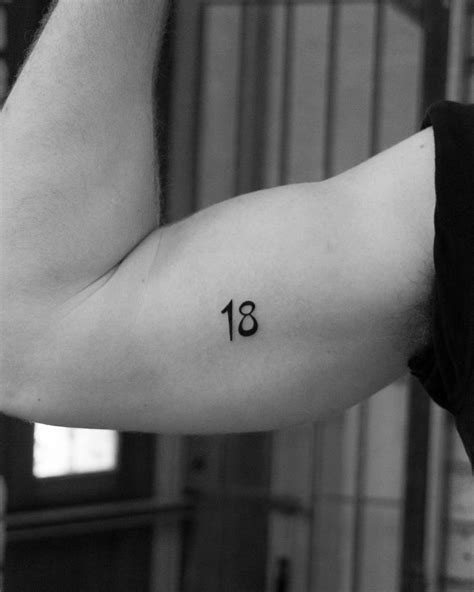 Number "18" tattoo done on the bicep.