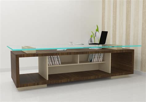 Add this comfortable and convenient office table to fit in a cabin. This glass top table wit ...