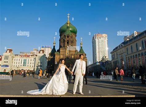 China, Northeast China, Heilongjiang Province, Harbin City. A wedding couple pose for photos in ...