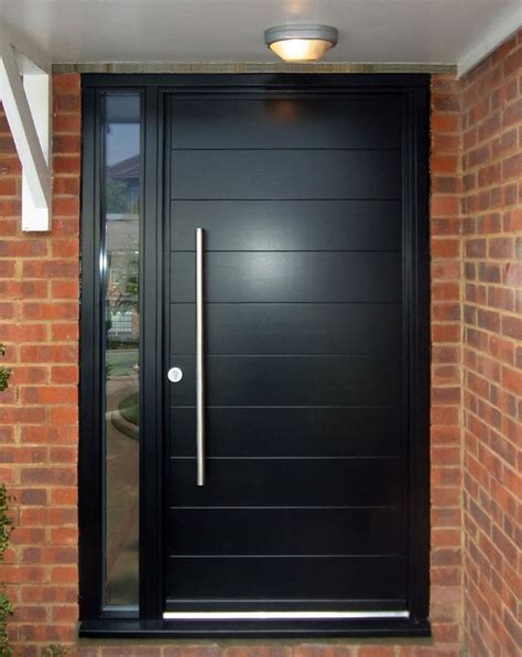 a modern black front door with glass and metal handle