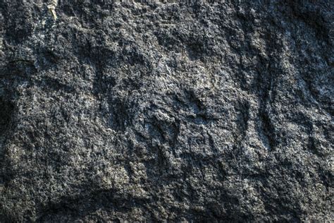 Raw gray granite rock texture background. Fragment of natural stone wall. Cracked, backdrop ...