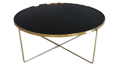 a black and gold coffee table with metal legs