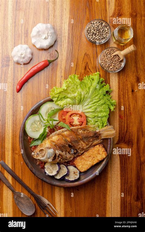 Crispy fried fish with spicy chili Sauce or sambal in pottery plate on ...