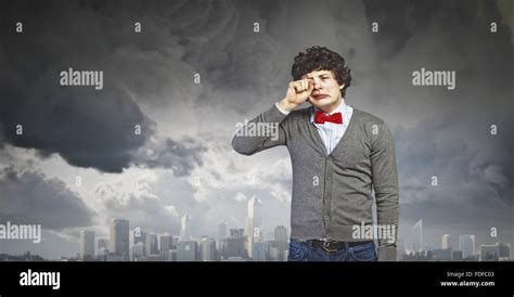 Image of young upset man in red tie crying Stock Photo - Alamy