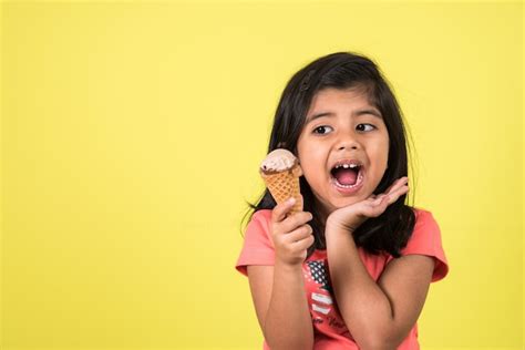 Premium Photo | Indian or Asian cute little kids eating Ice cream or mango bar or candy ...