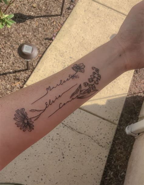 Names with flowers forearm tattoo. Lily of the valley tattoo, daisy ...