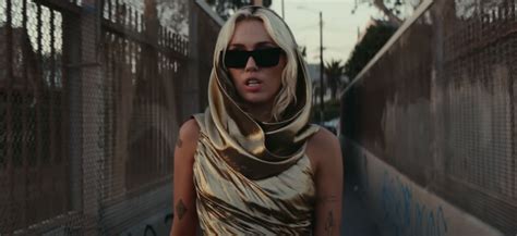 Miley Cyrus Wears Gold Cutout Dress in "Flowers" Music Video | POPSUGAR ...