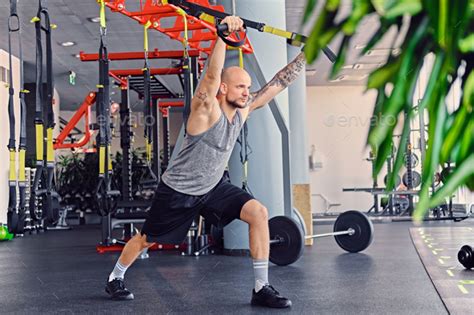 A man doing trx straps exercises Stock Photo by fxquadro | PhotoDune