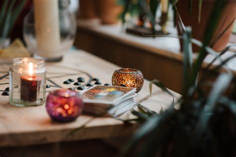 Set of tarot cards and glowing candles on desk · Free Stock Photo