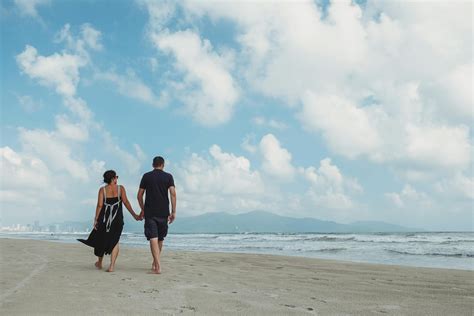 Couple Walking At The Beach · Free Stock Photo