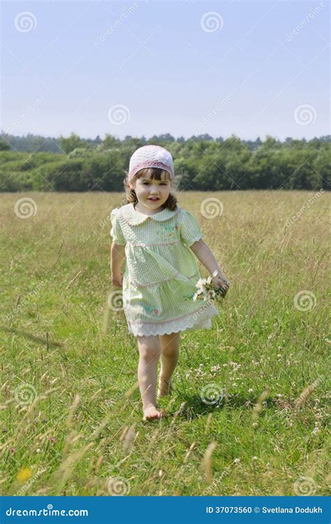 Little Barefoot Girl with Flowers Runs among Grass Stock Photo - Image ...