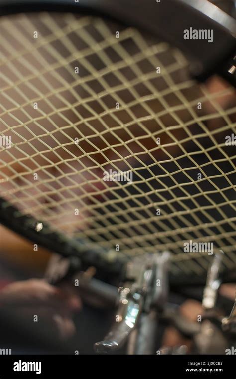 Racket stringing. Detail of tennis racket in the stringing machine Stock Photo - Alamy