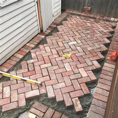 Making progress on our current project with some old red brick paving in 45 degree herringbone # ...