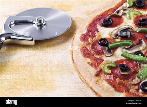 pizza and pizza cutter Stock Photo - Alamy