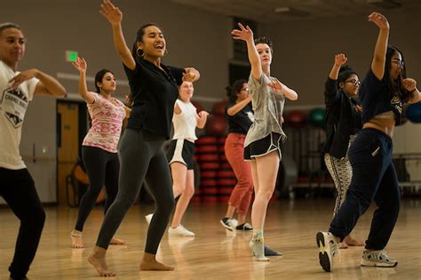 Students dancing exuberantly in a UVM dance studio