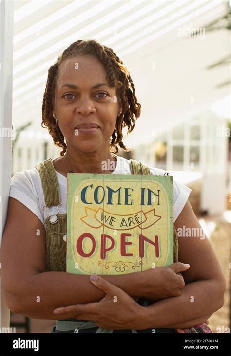 Portrait confident female plant nursery owner with open sign Stock Photo - Alamy