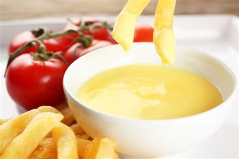 Premium Photo | Delicious french fries with cheese sauce closeup