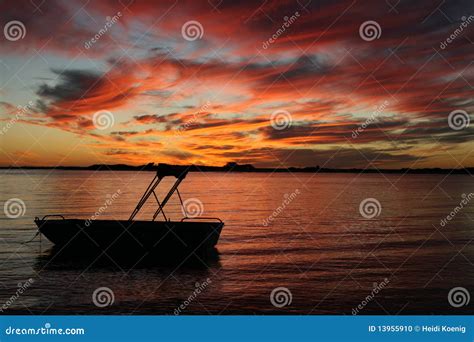 Silhouette of a Boat in Water Sunset Stock Photo - Image of mottled, loneliness: 13955910