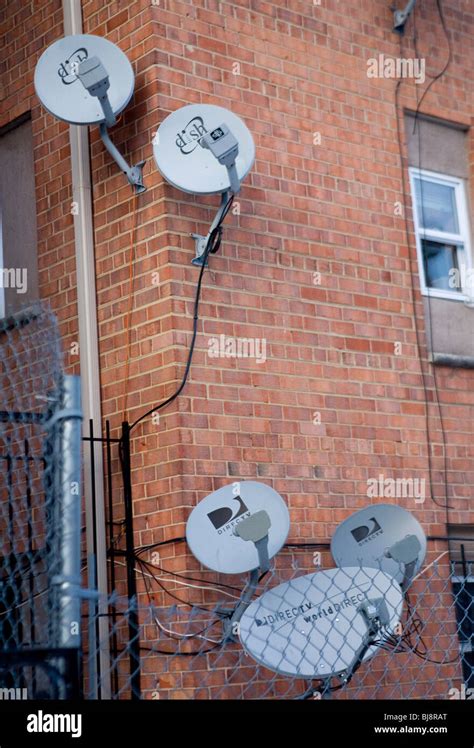 DirecTV and Dish Network satellite dishes on an apartment building ...