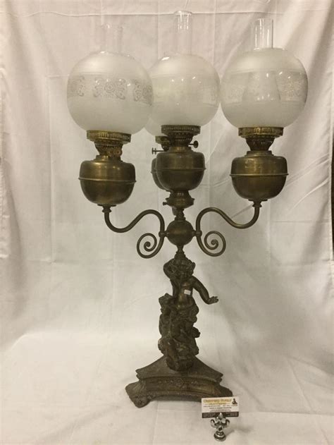 Sold Price: Antique brass oil lamp w/ four globe hurricane shade lights & cherub design base ...