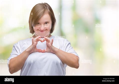 Young adult woman with down syndrome over isolated background smiling ...