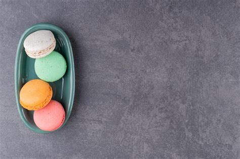 Free Photo | Colorful macarons dessert placed on a stone table