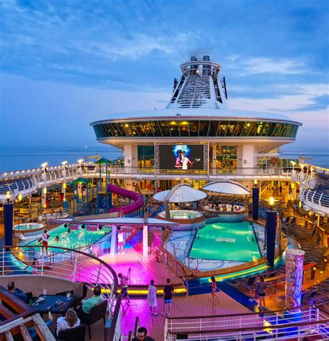 Royal Caribbean Cruise pool Deck lit up at night with lights - Travel Off Path